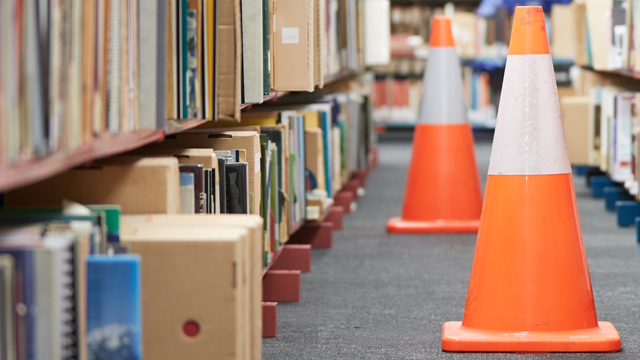 Safety cones by bookshelves