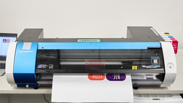 Samantha the vinyl printer and cutter shown printing stickers. 