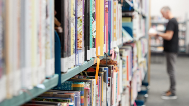 Man looking at books