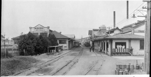 1924 image of concrete dairy factory on both sides of railway lines.