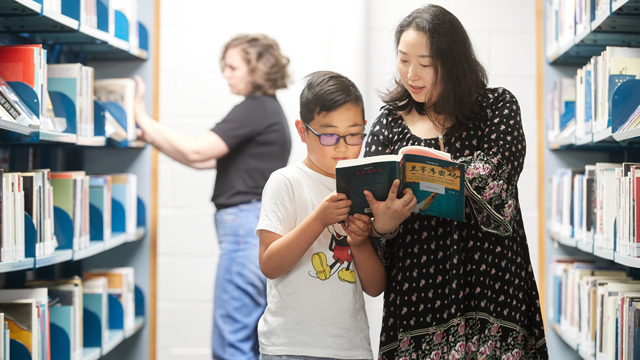 Mother and son looking at a book.