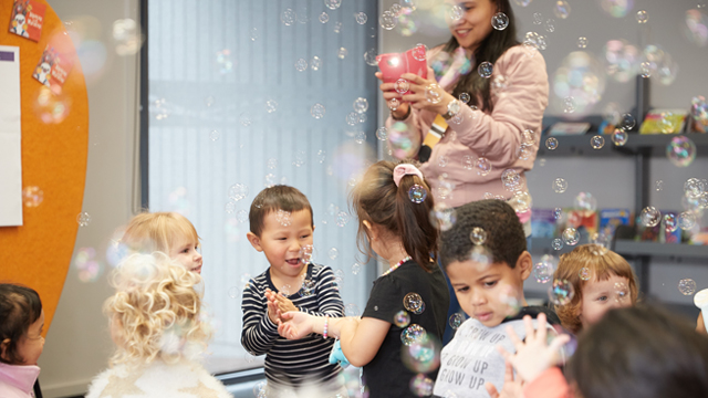 preschoolers enjoying bubbles at a library event.