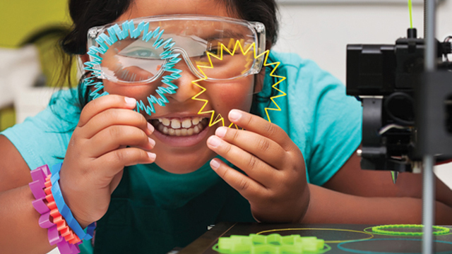 A child looking through stencils and enjoying themselves. 