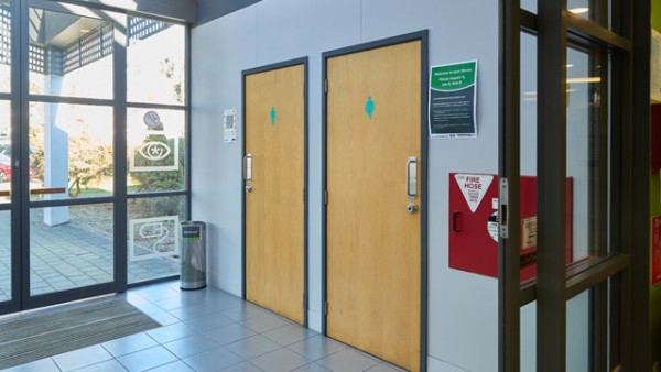 The toilets are located by the main entrance at Glenview Library before the second set of doors.