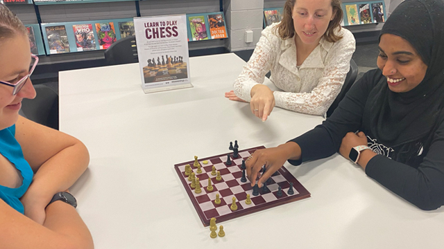 three women playing chess