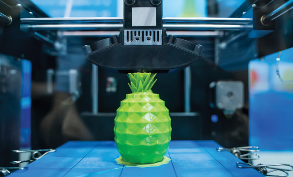 A green pineapple in a 3D printer.